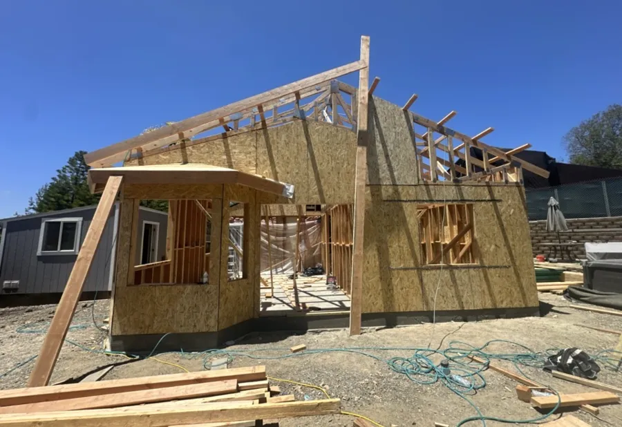 Room addition framed with the roof rafters going up