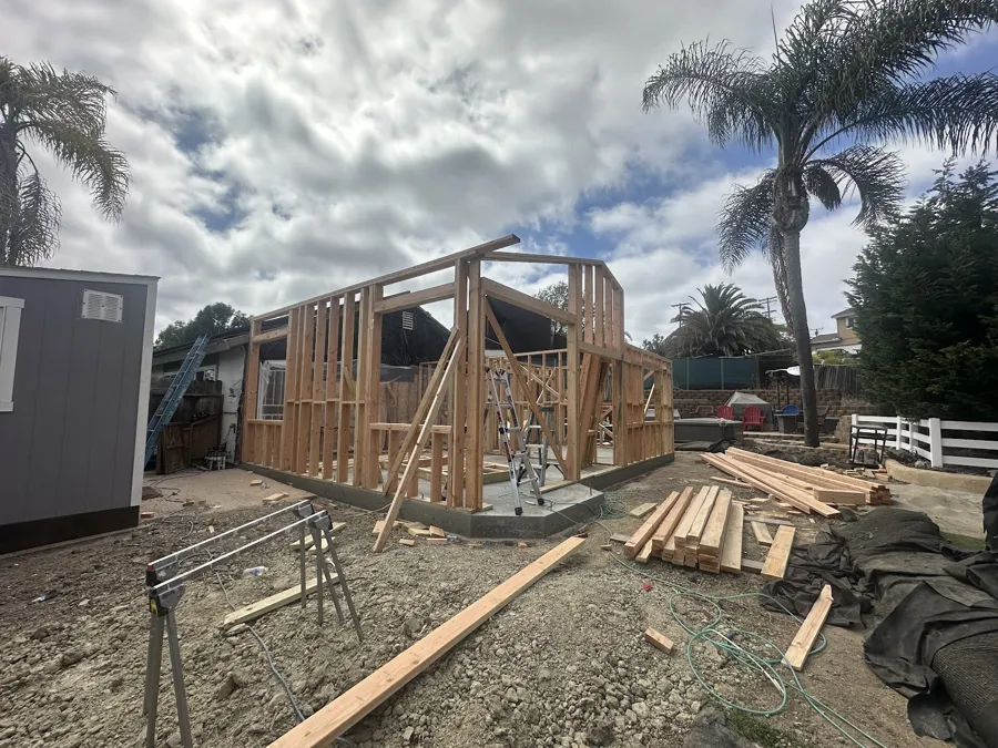 Wall framing going up for a room addition on a new slab